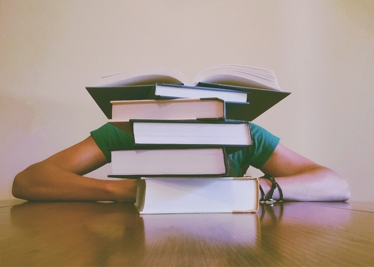 Student buried behind books