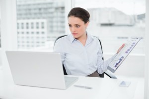 A budget analyst reviews her company’s financial report.