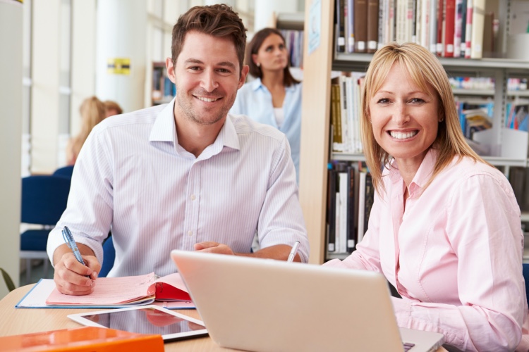 A department head assists a student.