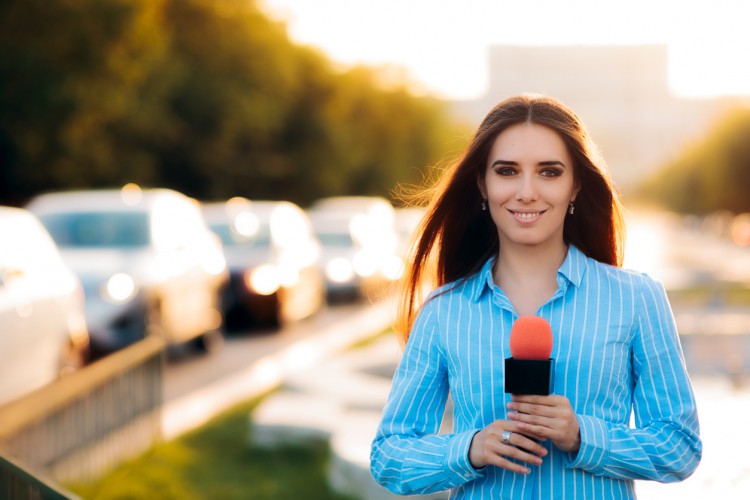 A reporter broadcasts from the city.