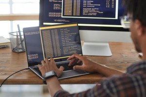 A computer scientist codes on a screen