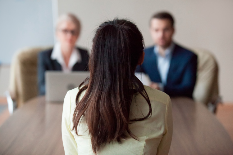 a female employee faces a review board