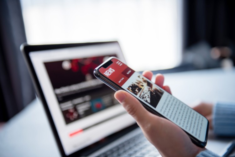 A user reads political news on a cellphone.