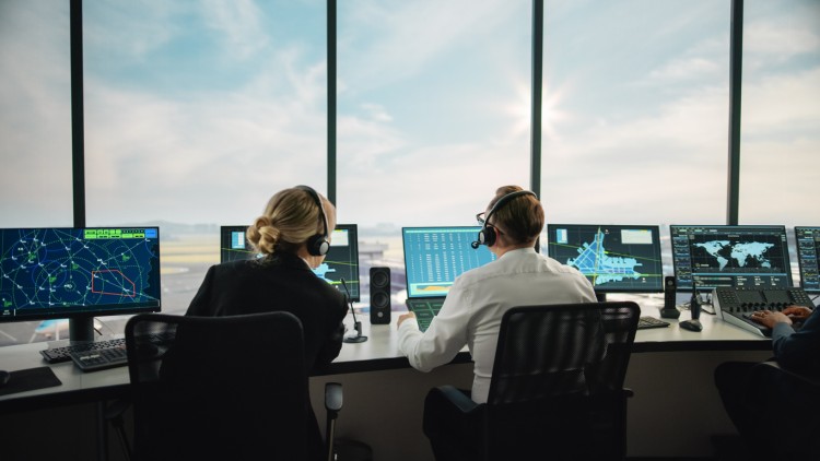 Air traffic controllers supervising the air traffic.