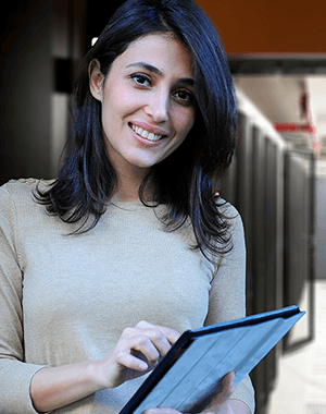 woman wearing a jersey, holding a tablet and smiling