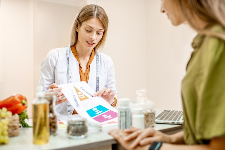 A nutritionist explains a diet plan to a client.