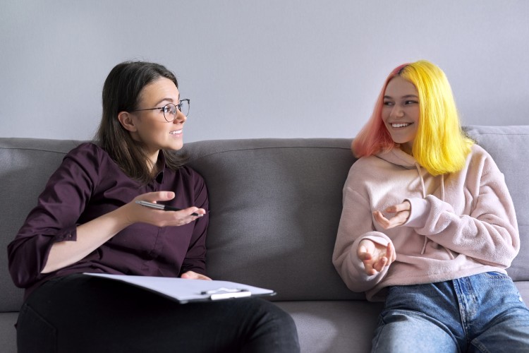 A school social worker counseling a teenager.