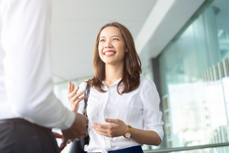 A smiling social worker greets a client.