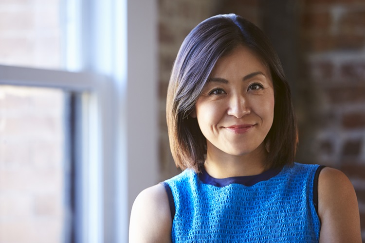 Portrait Of Businesswoman In Office Standing By Window