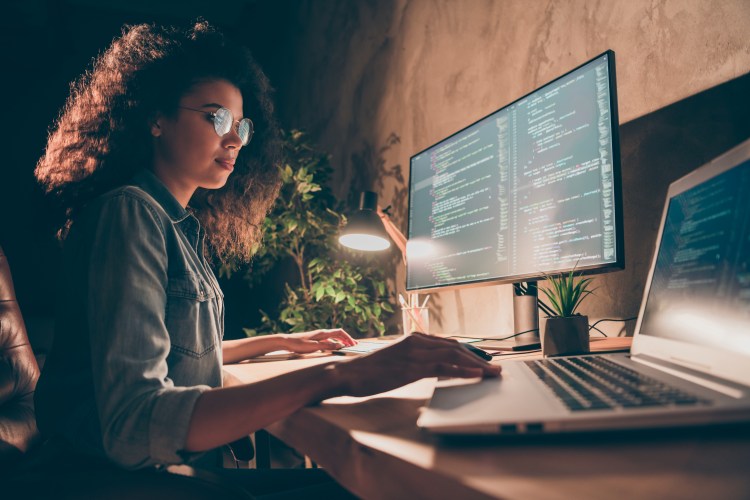 A computer scientist works at her desk.