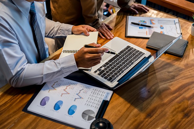 A financial manager reviews financial documents.