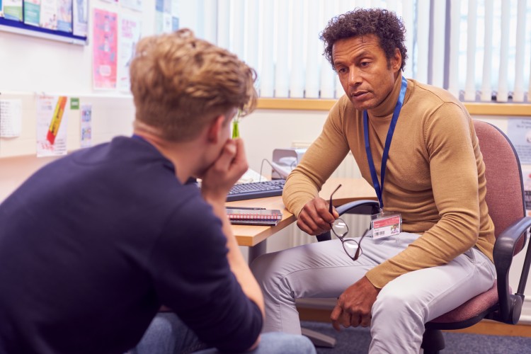 A guidance counselor meets with a high school student to discuss the student’s plans for after graduation.