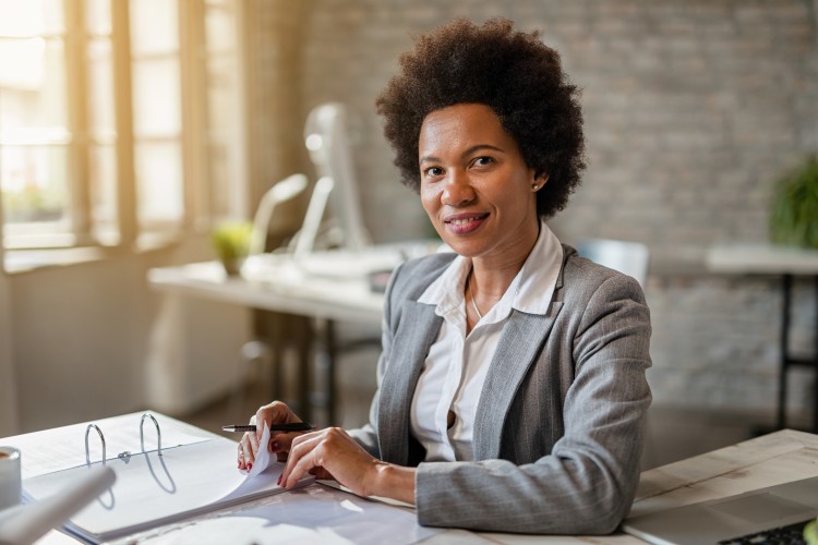 Female investment banker smiling.