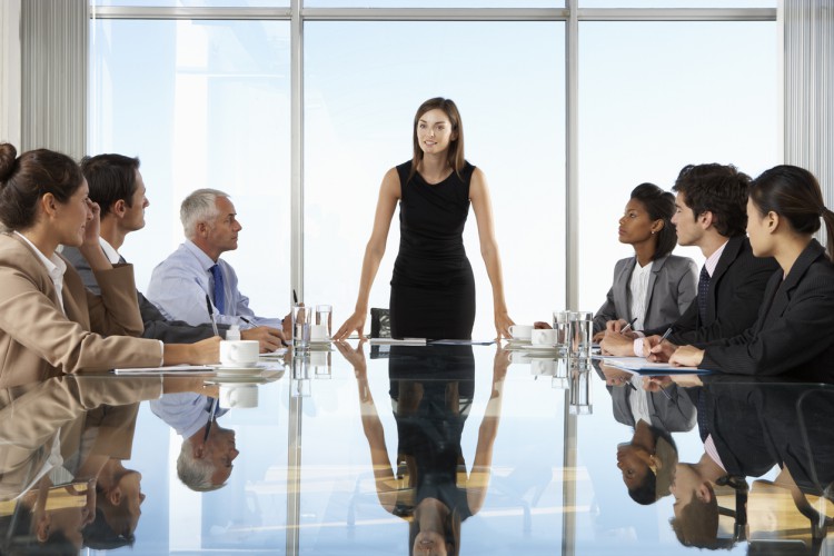 Leader speaking to her team in a board meeting.