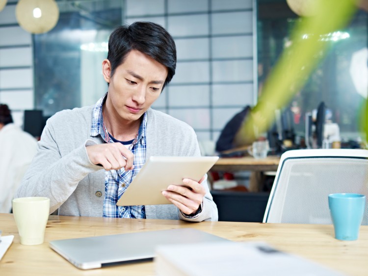 Marketing associate working with a tablet.