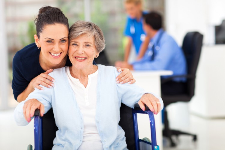 A nursing home director spends time with a resident.