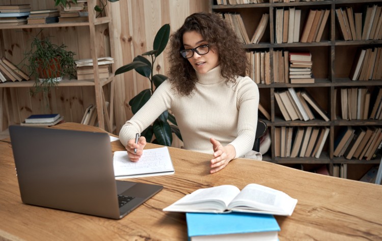 A social work student attends an online class.