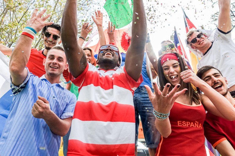 Sports fans outside a stadium cheer for their various national teams