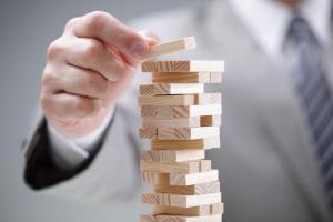 a hand building a block tower