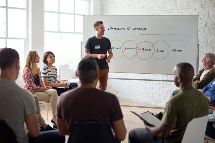 Wellness director gives a presentation to a small group of employees