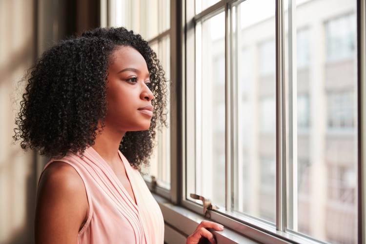 Woman staring at the window.