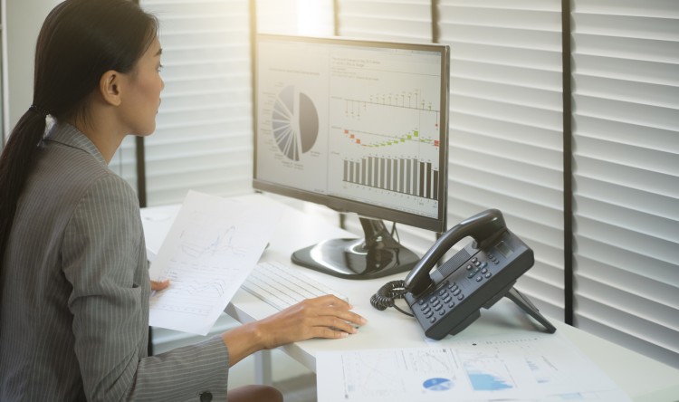 Data analyst working in her desktop.