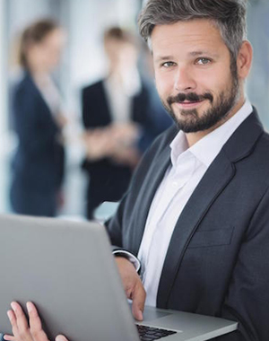 man standing with laptop