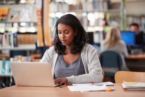 A student takes an exam on a laptop using blockchain technology.